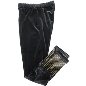 Detail view of black velvet leggings with gold and silver rhinestone trim at the cuffs