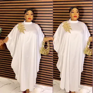 Elegant white African kaftan dress featuring gold floral embroidery and batwing sleeves