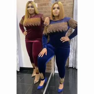 Full length detail of African women's velvet tracksuit with gold rhinestone tassels