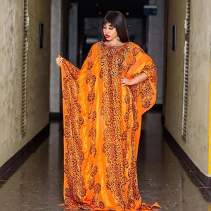 Elegant African chiffon kaftan dress with rhinestones and beads in bright orange.