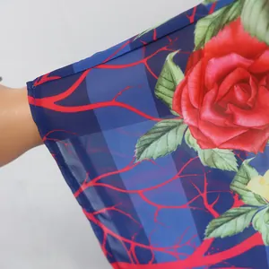 Detail view of floral print on blue striped chiffon fabric for African ethnic dress