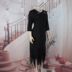Elegant black midi dress with decorative buttons and stylish fringe hem detail.