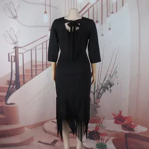 Detailed back view of an elegant black mid-sleeve dress featuring tassel fringe and bow tie
