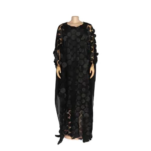 Close-up of black African maxi dress with 3D polka dot floral embroidery detail