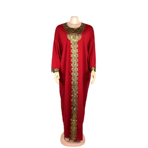 Red African style maxi dress featuring detailed gold lace embroidery on neckline