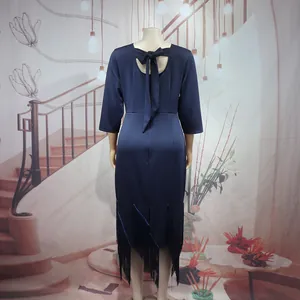 Back view of elegant navy blue midi dress with bow tie and tassel hem detail