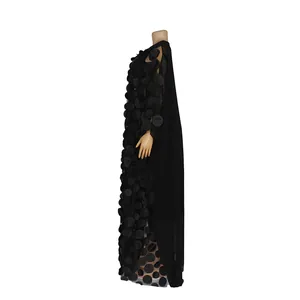 Close-up side view of black African maxi dress with elegant 3D textured circle applique