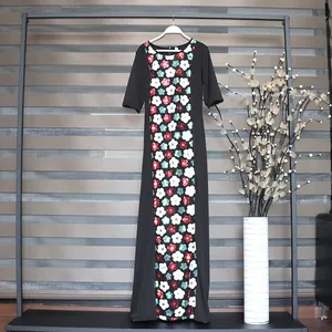 Full view detail of an African-style maxi dress featuring vibrant floral sequin embroidery.