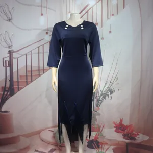 Close-up of navy blue three-quarter sleeve dress with fringe hem and silver buttons