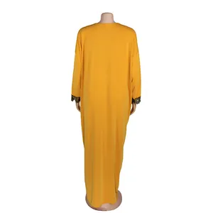 Back view of African style yellow maxi dress with lace-trimmed cuffs