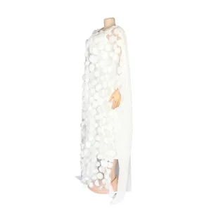 Side view detail of a white African maxi dress featuring 3D floral applique