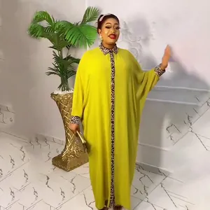 Full-length view of a yellow African kaftan dress featuring leopard print trim details