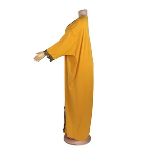 Side view of an African style yellow stretch maxi dress with lace trim sleeves.