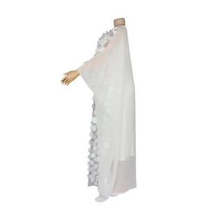 Detailed side profile of white African maxi dress featuring elegant 3D floral embroidery