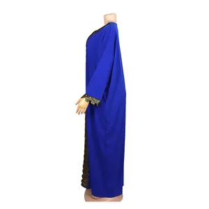 Detailed side profile of a blue African style maxi dress with intricate gold lace trim