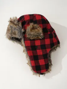 Detailed view of a red and black buffalo plaid trapper hat featuring warm faux fur ear flaps