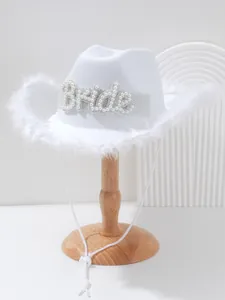 Detailed close-up view of white bridal cowboy hat with pearls, feathers, and rhinestones