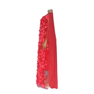 Side view detail showing the 3D floral petal appliques on a red African maxi dress