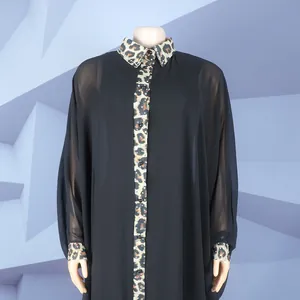 Detailed macro view of black chiffon robe with leopard print and rhinestone accents