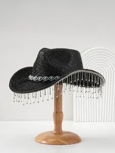 Black glitter cowboy hat with long rhinestone tassel fringe on a wooden stand.