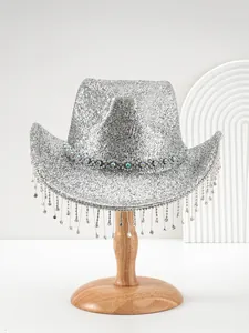 Detailed macro view of silver glitter cowboy hat with rhinestone band and crystal tassels.