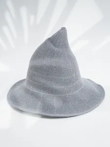 Macro view of a grey knitted pointed witch hat showing the high-quality woven texture