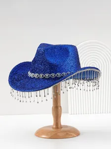 Close-up of royal blue glittery cowboy hat with heavy industry rhinestone fringe tassels.