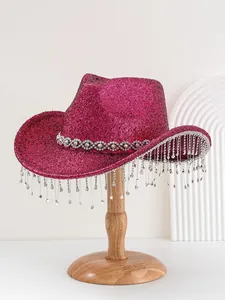 Detailed view of heavy rhinestone fringe and crystal band on magenta glitter cowboy hat