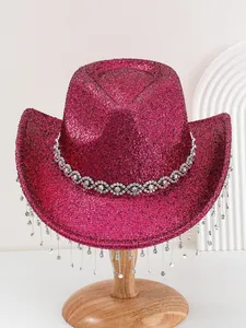 Close-up of wine red glitter cowboy hat with sparkling rhinestone fringe details