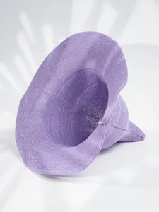 Detailed close-up of a purple knitted pointed witch hat for Halloween party wear.