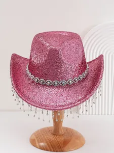 Close-up of pink glitter cowboy hat featuring sparkling rhinestone fringe tassels.