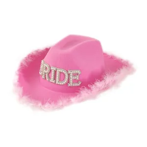 Pink bridal cowboy hat featuring fluffy feather trim and pearl rhinestone BRIDE lettering