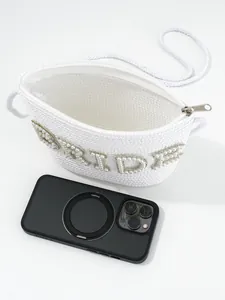 Detailed view of white woven bridal bag with pearl BRIDE lettering and zipper closure