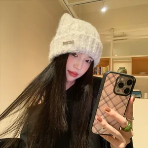 Charming grey cat-ear knitted beanie for women featuring a cozy and warm plush texture
