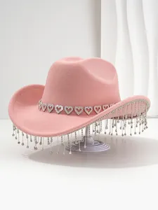 Close-up of pink felt cowboy hat featuring heart rhinestone band and sparkling fringe detail.