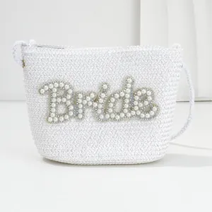 Elegant white woven bride crossbody bag featuring pearl and rhinestone letters design