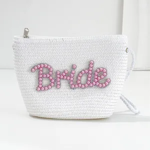 White woven bride crossbody bag with pink pearl and rhinestone letter embroidery.