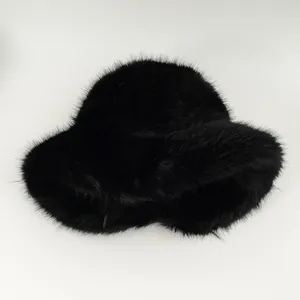 Detailed macro shot of a black plush women's bucket hat with fluffy faux fur texture