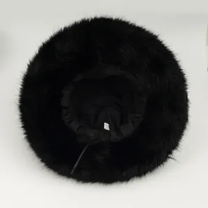 Top view detail of a warm black fuzzy faux fur hat showing the soft interior lining.