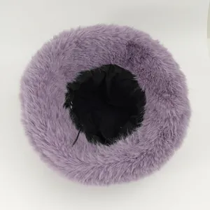 Close-up detail of a plush purple faux fur bucket hat with a warm black inner lining