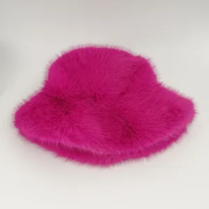 Detailed view of a vibrant pink faux fur bucket hat featuring a soft plush texture for winter