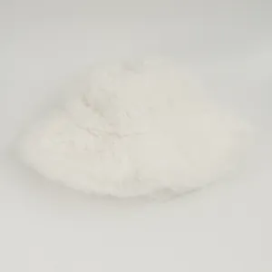Macro view of a warm white fluffy faux fur bucket hat with soft plush texture details