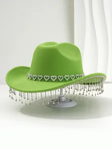 Detailed view of bright green felt cowboy hat featuring heart rhinestones and crystal fringe