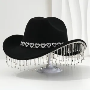 Elegant black cowboy hat for women featuring silver heart band and sparkling rhinestone tassels
