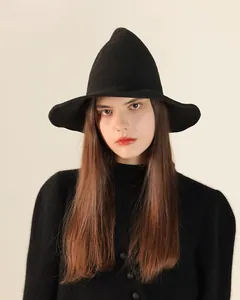 Macro detail of a black knitted pointed witch hat, perfect for Halloween styling outfits