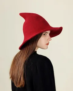 Side profile of a red knitted witch hat showing high-quality woven texture and curved peak