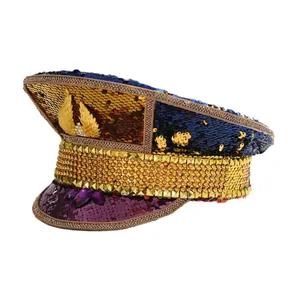 Y2K style captain's hat with colorful sequins, gold wing emblem, and purple gemstone accents