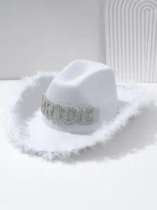 Close-up detail of white bridal cowboy hat with rhinestone BRIDE letters and feather trim