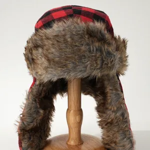 Red and black checkered trapper hat with warm faux fur lining for winter outdoor sports.