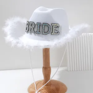 Elegant white rhinestone BRIDE cowboy hat with fluffy feather trim for wedding parties.